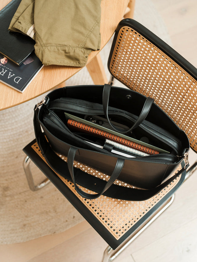 CALPAK Haven 16" laptop tote in black,  top view with bag packed notebooks and laptop insert