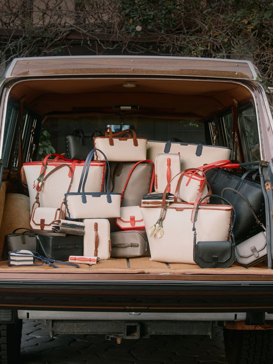 CALPAK Colette Canvas Bags in a trunk