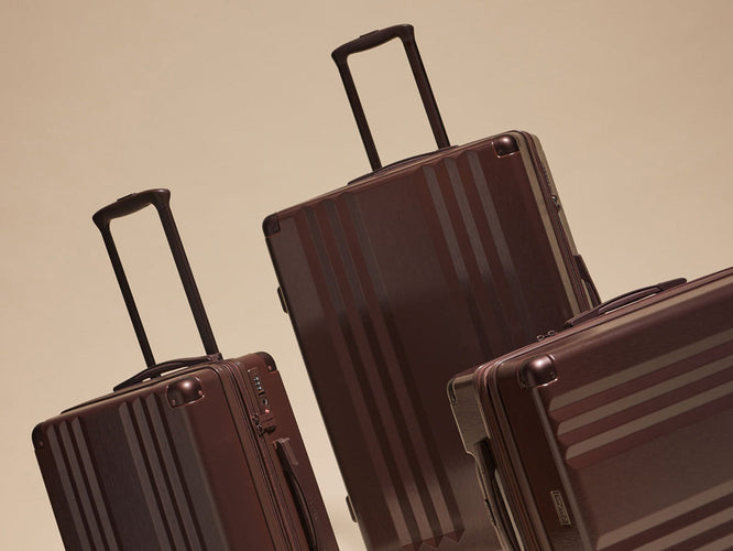 Ambeur 3pc Luggage Set in deep brown Walnut from CALPAK on a  beige background