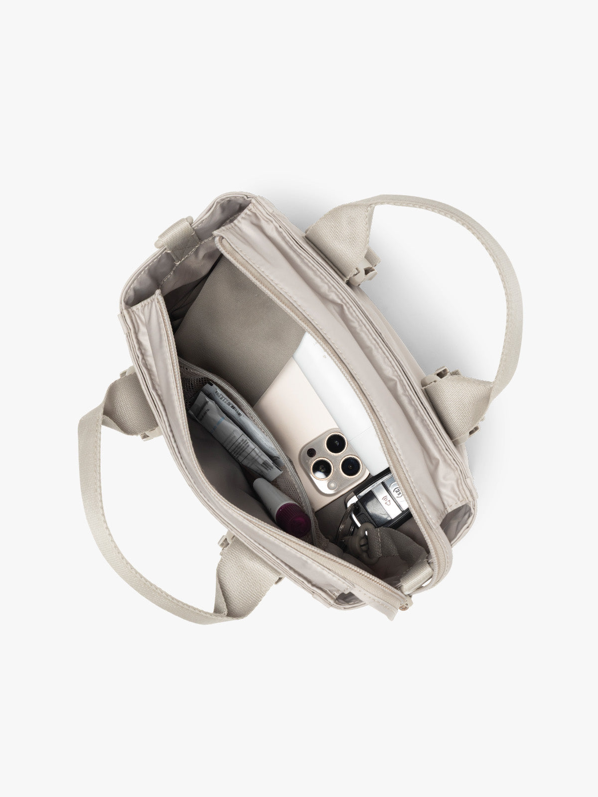 Inside of CALPAK Fit Gym Crossbody Bag in beige Greige with white background; ABF2601-GREIGE