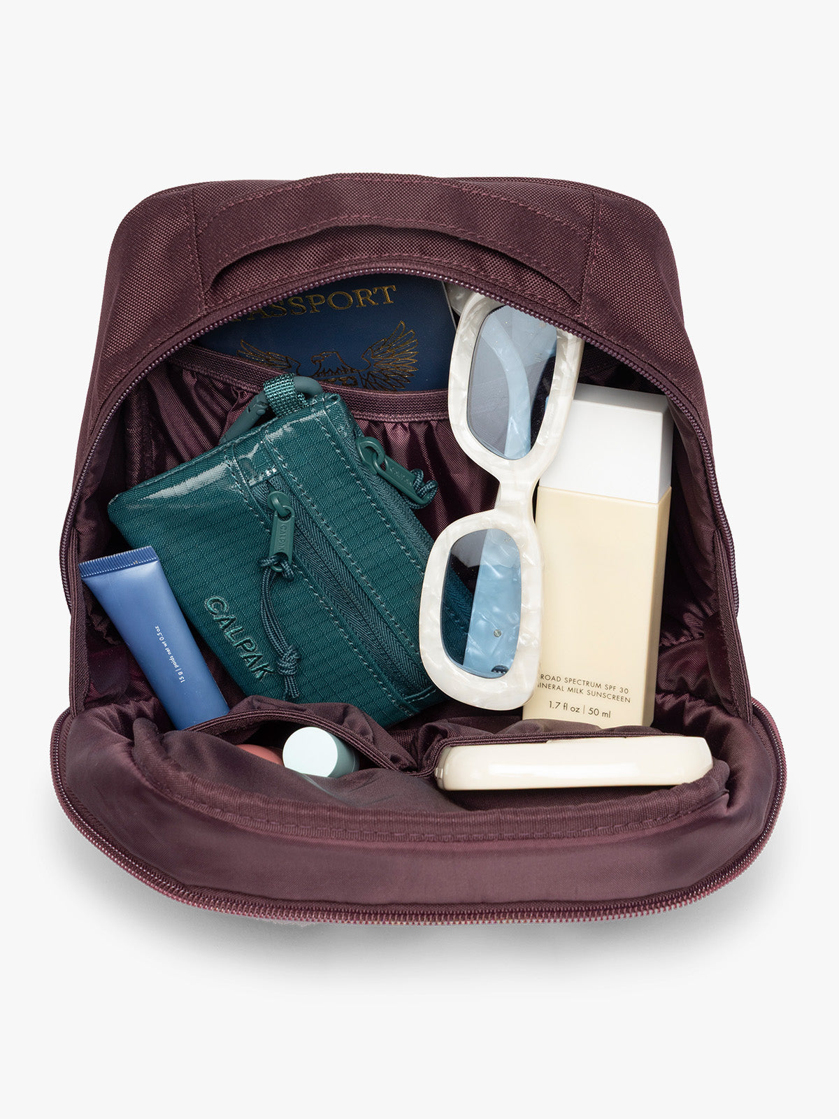 Inside the Dark burgundy Dark Cherry color of the CALPAK Everything Cube organizer with a top handle, a front zippered pocket, and a textured mesh lower panel, shown against a plain white background; ACE2401-DARK-CHERRY