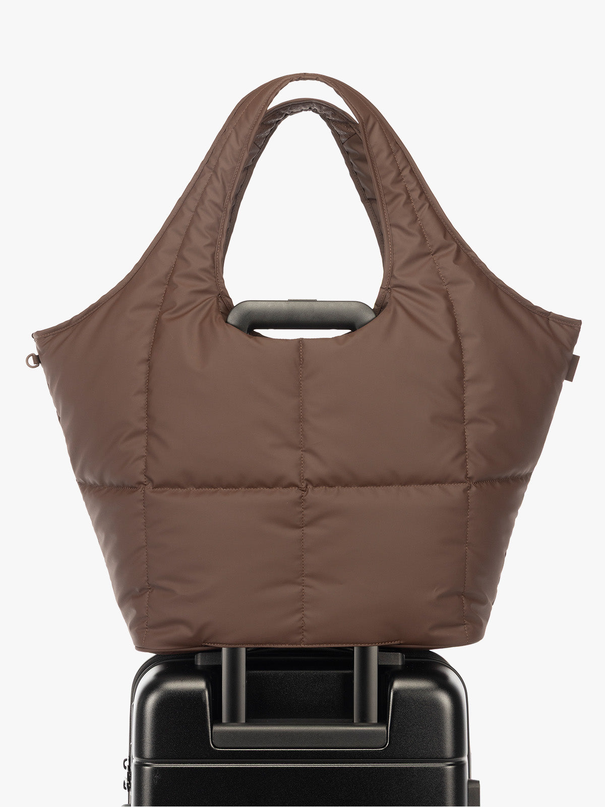 Luggage trolley sleeve of the CALPAK Luka Everything Laptop tote in brown Walnut with shoulder strap on a white background; AET2601-WALNUT