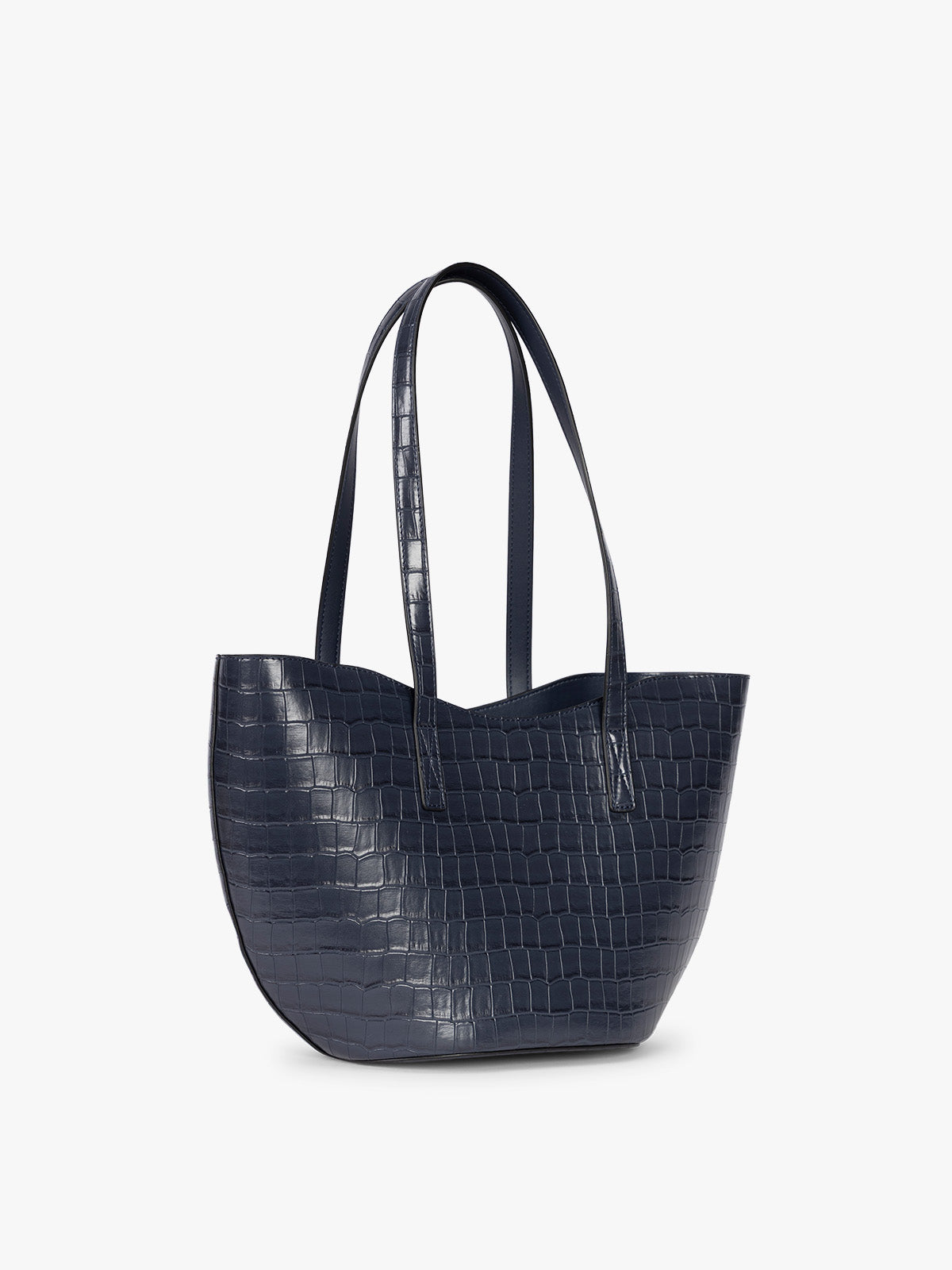 Side view of a navy blue crocodile-embossed CALPAK Haven Tulip tote bag with double shoulder straps against a plain white background; AHP2601-NAVY-FAUX-CROC