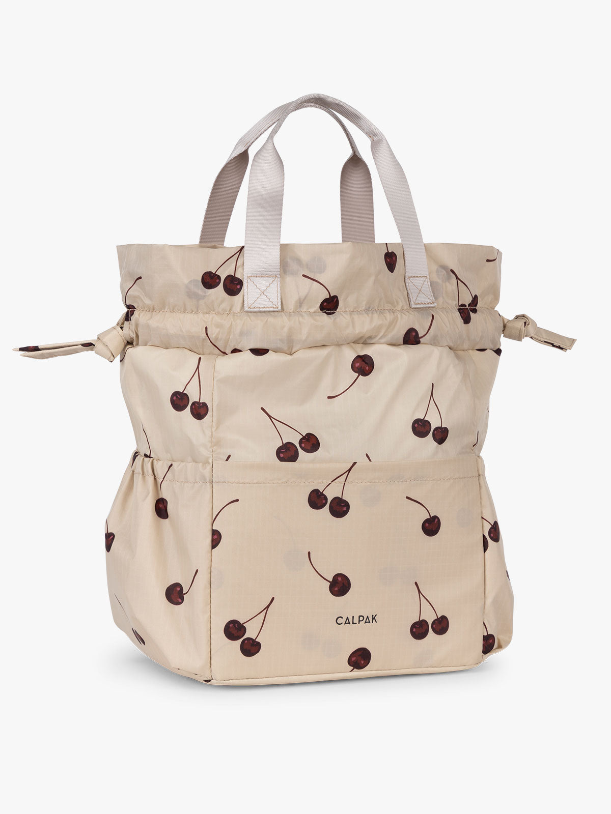CALPAK Insulated Lunch Bag in Oatmeal Cherry in tan with cherry print with drawstring showing full height; ALB2001-OATMEAL-CHERRY
