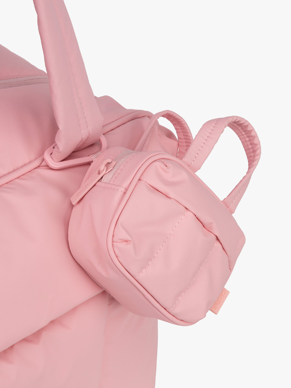 CALPAK Luka Duffel Key Pouch in pink Blossom clipped onto bag; ALK2501-BLOSSOM