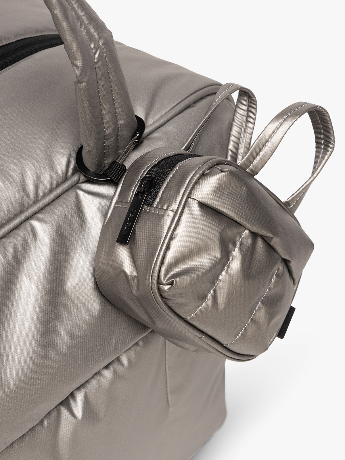 CALPAK Luka Duffel Zip Bag Charm in dark silver Gunmetal attached to bag; ALK2501-GUNMETAL