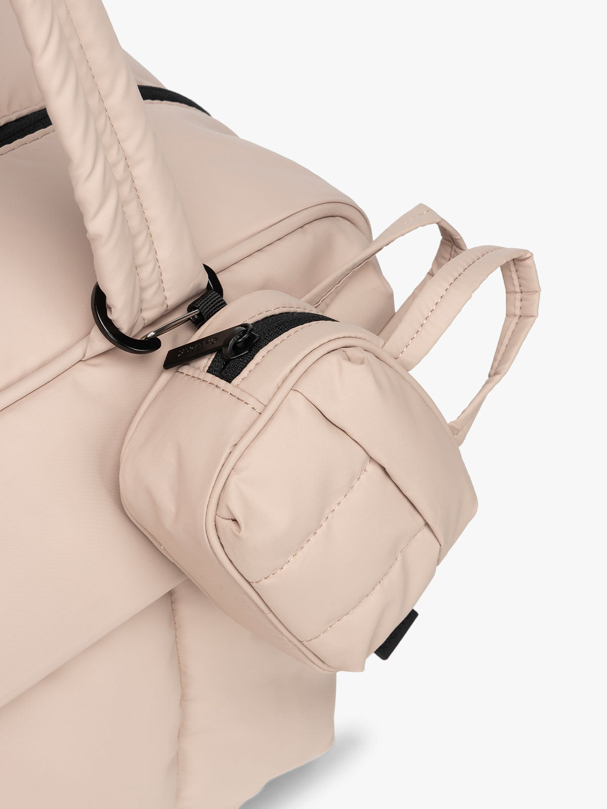 CALPAK Luka Duffel Key Pouch in pink Rose Quartz clipped onto the Luka Duffel in pink Rose Quartz; ALK2501-ROSE-QUARTZ