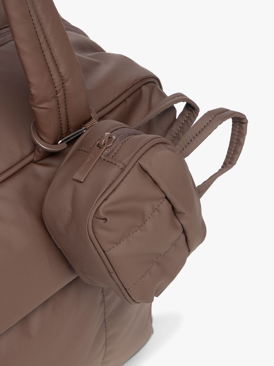 CALPAK Luka Duffel Key Pouch in brown monochrome Walnut attached to a Luka Duffel in brown Walnut; ALK2501-WALNUT