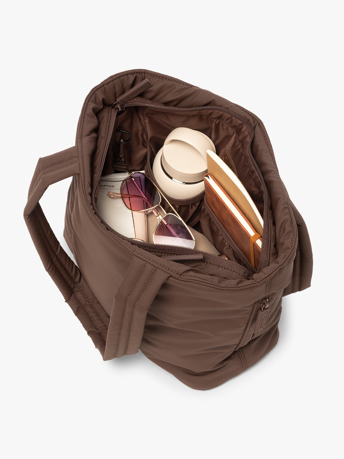 CALPAK Luka Mini Tote in brown monochrome Walnut interior view with notebooks, water bottle, and sunglasses; ALM2401-WALNUT