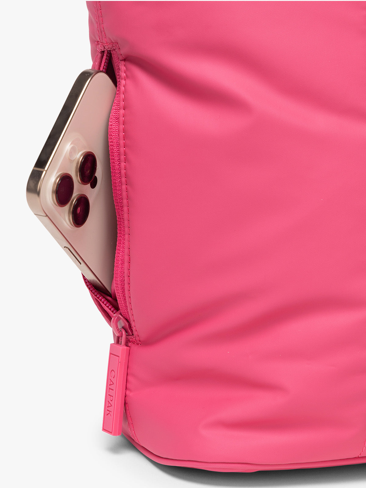 Side zippered pocket of CALPAK Luka Mini Tote in bright pink Dragonfruit on a white background; ALM2401-DRAGONFRUIT