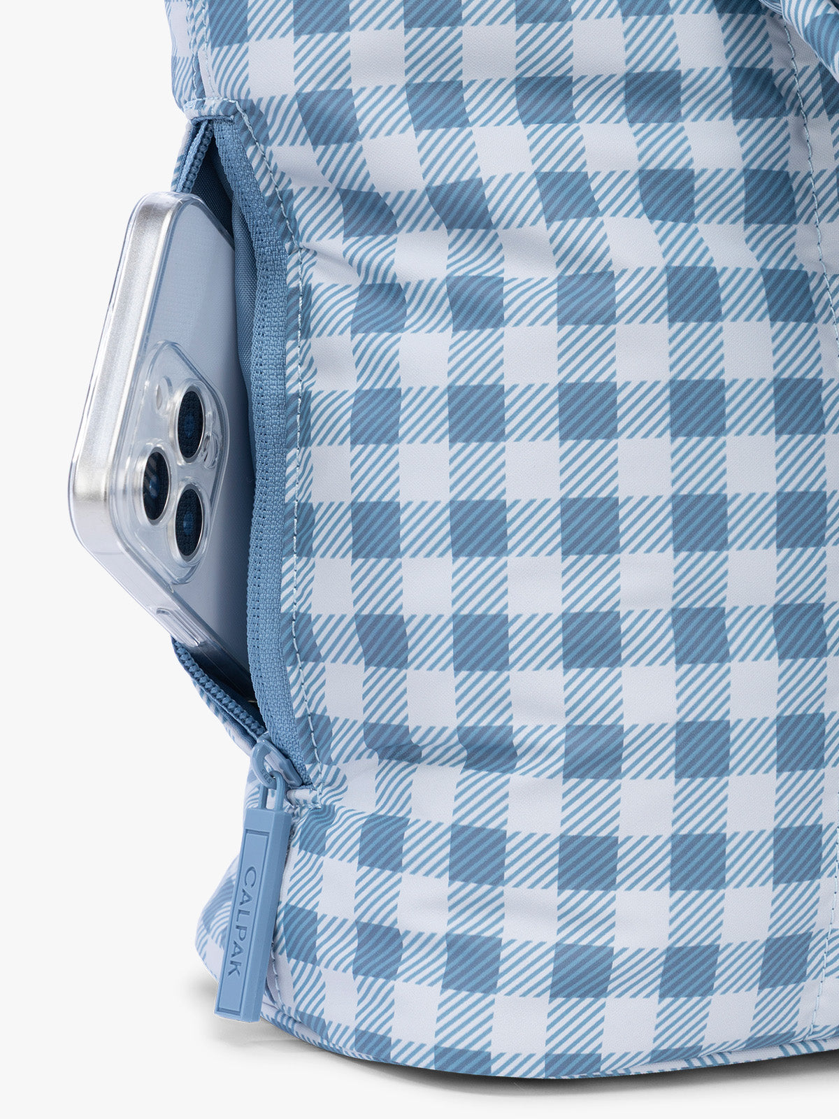 Side phone pocket with zipper of CALPAK Luka Mini Tote in white and blue gingham pattern in French Blue Gingham ; ALM2401-FRENCH-BLUE-GINGHAM