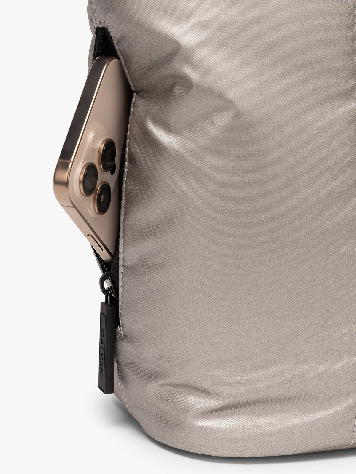 Side zip phone pocket of CALPAK Luka Mini Tote in metallic Gumetal grey a white background; ALM2401-GUNMETAL