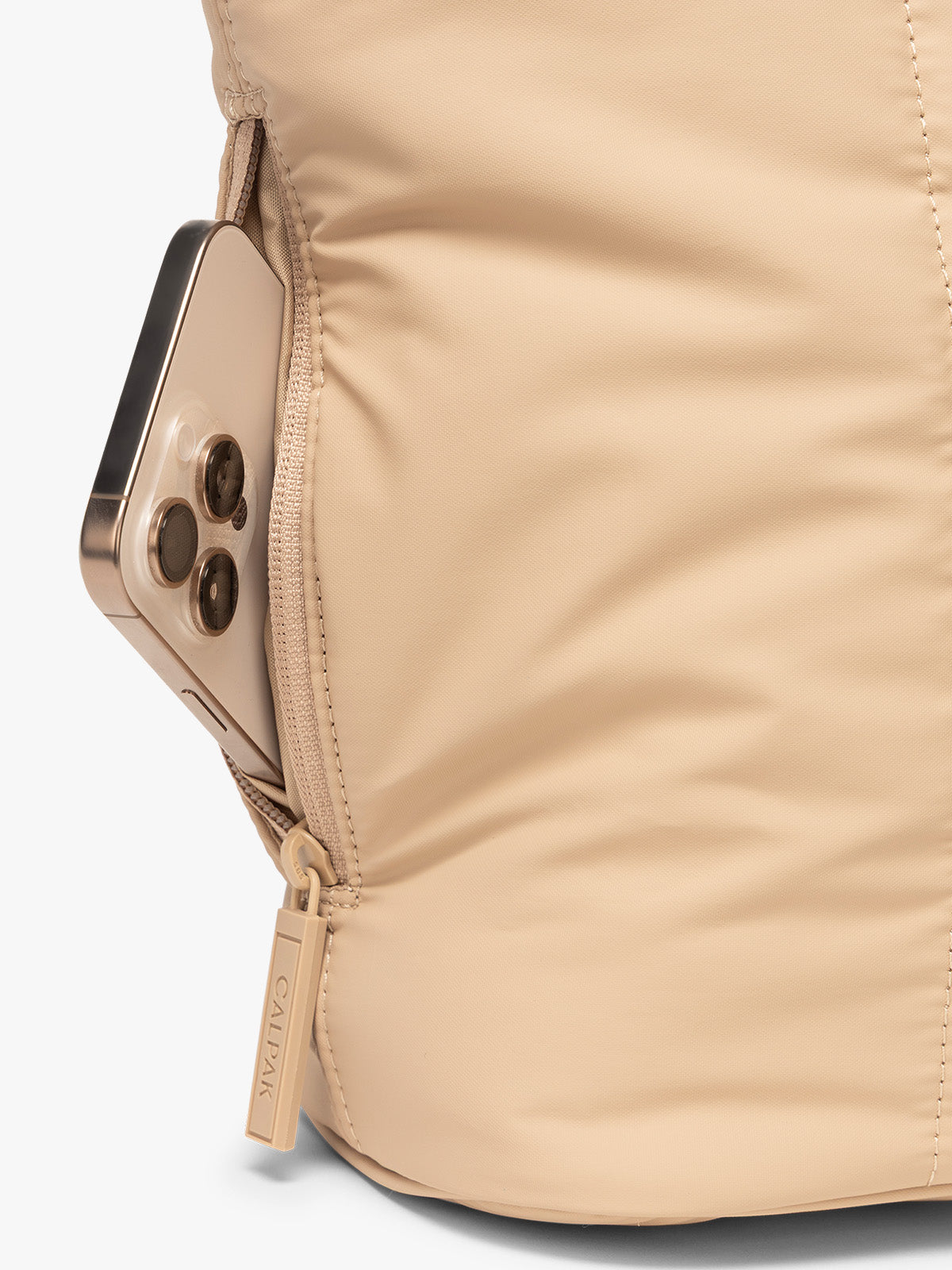 Side zip phone pocket of CALPAK Luka Mini Tote in beige Latte on a white background; ALM2401-LATTE