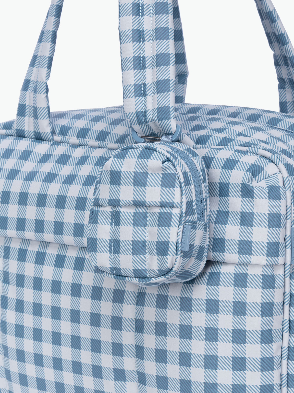 CALPAK Luka Backpack Zip Bag Charm in white and blue gingham print clipped on a bag; AMB2201-FRENCH-BLUE-GINGHAM