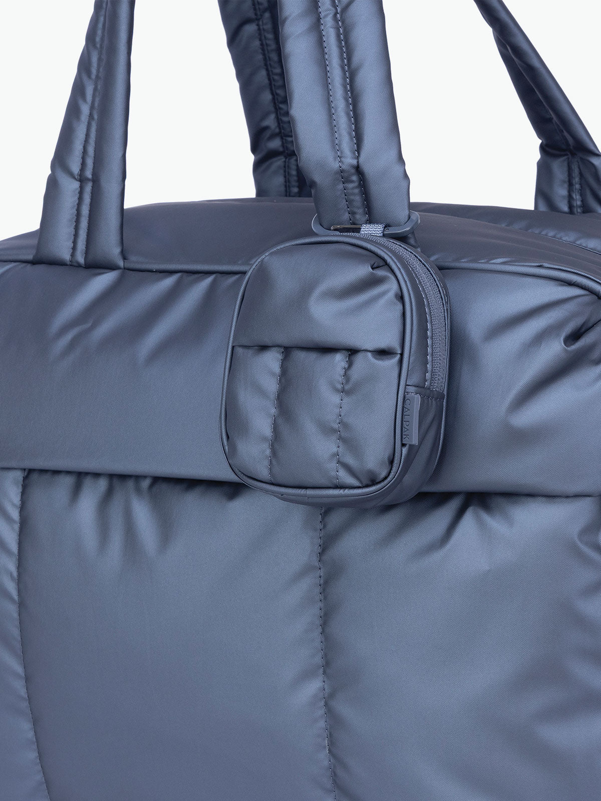 CALPAK Luka Backpack Zip Bag Charm in metallic dark blue Metallic Indigo clipped on bag; AMB2201-METALLIC-INDIGO