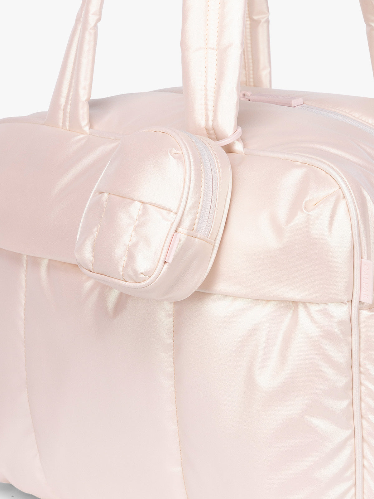 CALPAK Luka Backpack Zip Bag Charm in light pink Pearlescent clipped on bag; AMB2201-PEARLESCENT