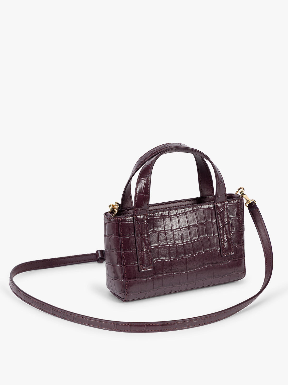 Side view with crossbody strap of CALPAK Haven Mini Crossbody Bag in deep red Dark Cherry crocodile-embossed with top handles on a plain white background; AMC2502-DARK-CHERRY-FAUX-CROC