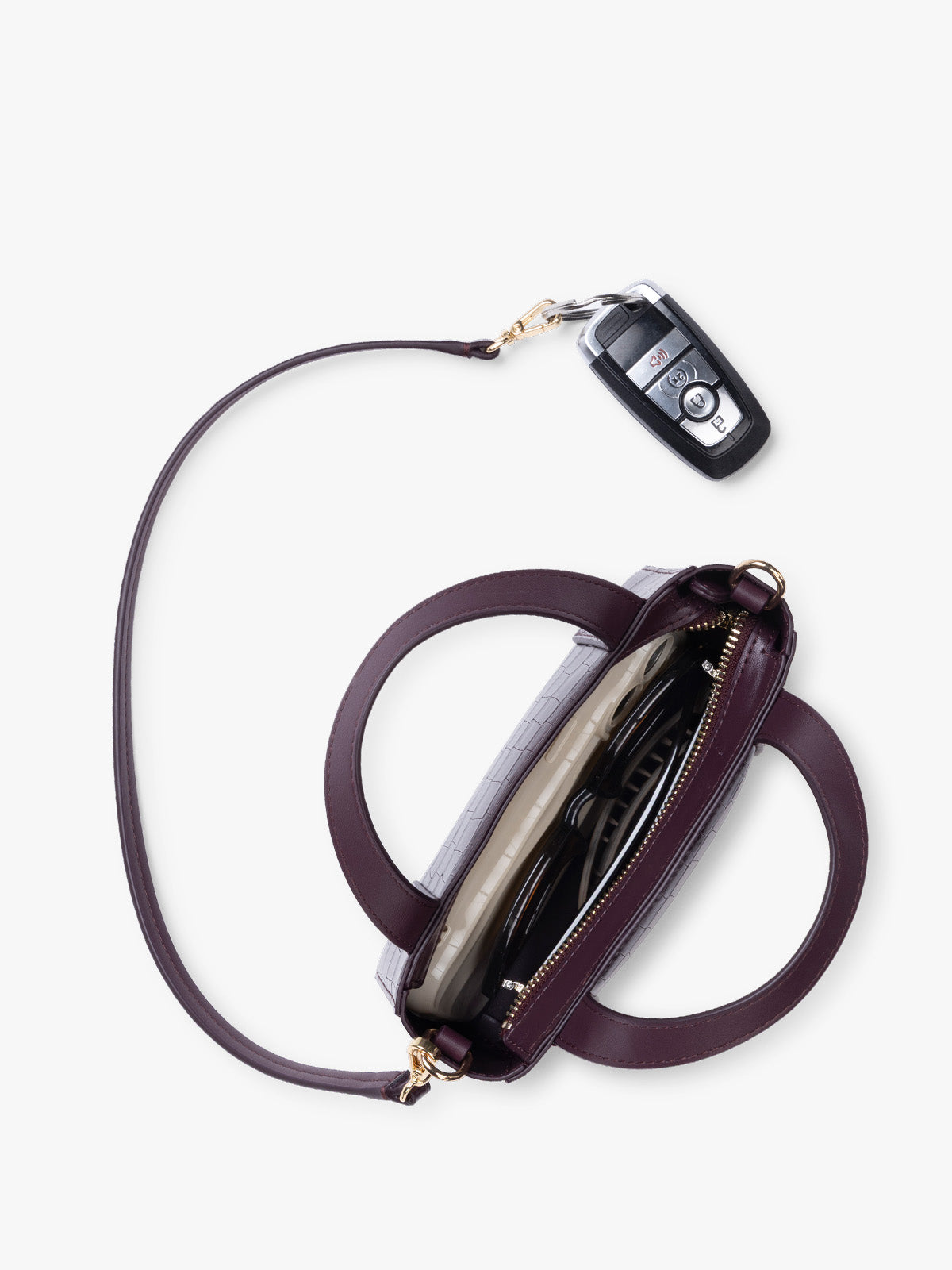 Top view and key line of CALPAK Haven Mini Crossbody Bag in deep red Dark Cherry crocodile-embossed with top handles on a plain white background; AMC2502-DARK-CHERRY-FAUX-CROC