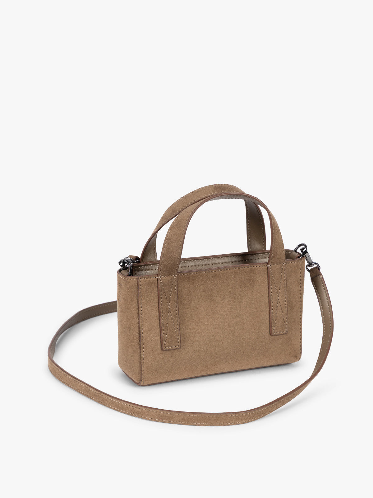 Side view with crossbody strap of CALPAK Haven Mini Crossbody Bag in brown Truffle Suede with top handles on a plain white background; AMC2502-TRUFFLE-FAUX-SUEDE