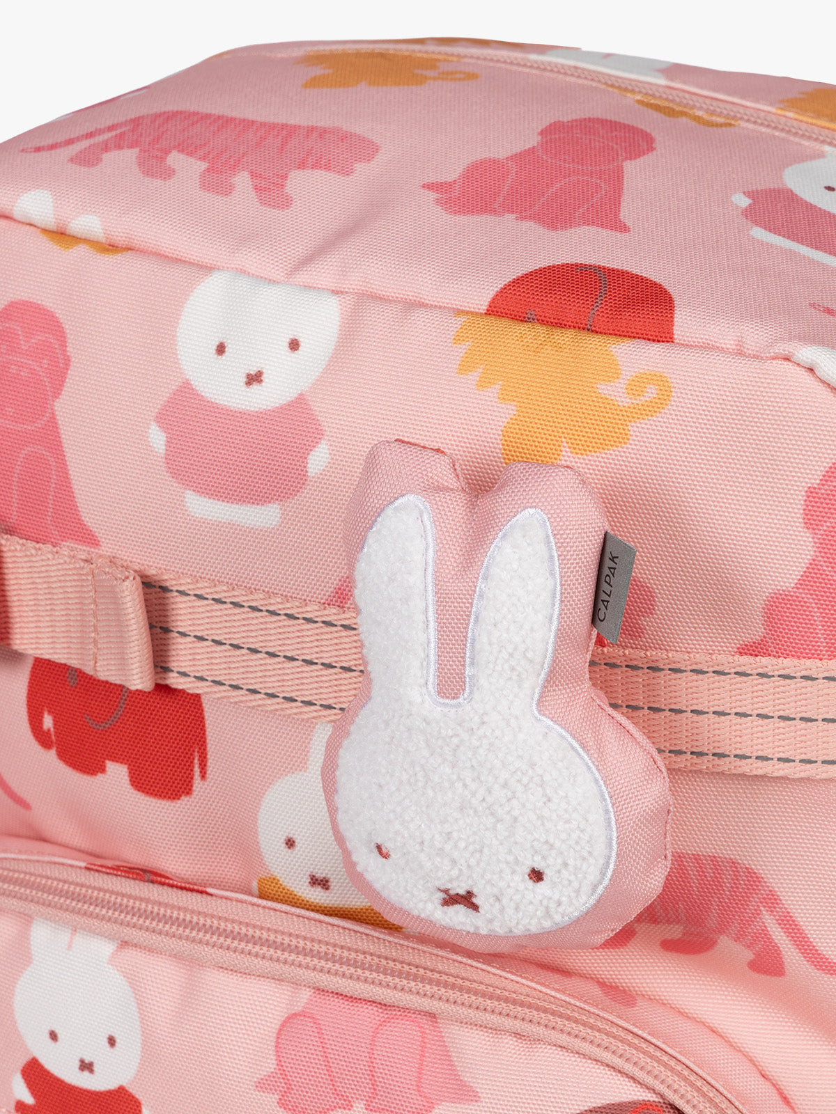 Colorful CALPAK + Miffy Kids Essentials Set with children's Medium backpack, lunch bag , pencil case set on a white background with pink accents and Miffy with other animals; BCKM5000-MIFFY-PINK-ZOO-TRIP