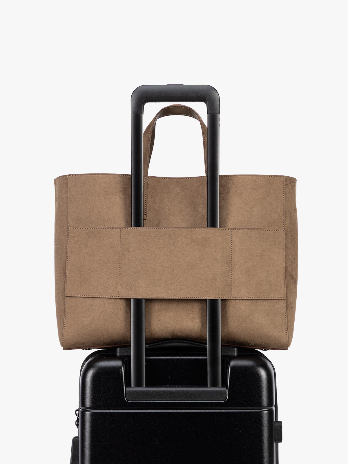 Backside laptop sleeve of a CALPAK Haven 16" Laptop Tote in Truffle Suede taupe brown tote bag with dual top handles and a matching adjustable shoulder strap, shown against a plain white background; ATO2102-TRUFFLE-FAUX-SUEDE