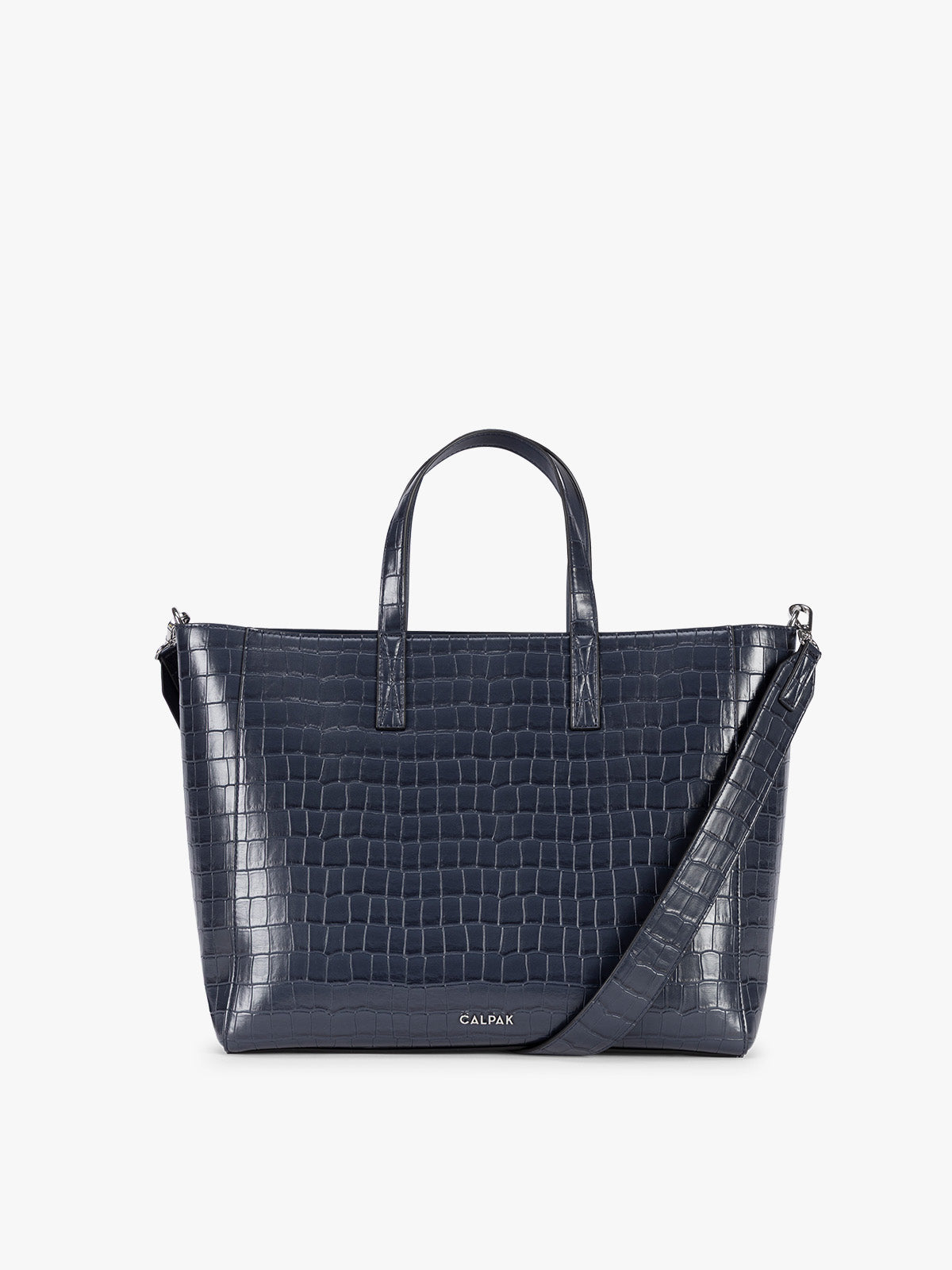 A navy CALPAK Haven 15" Laptop Tote in Navy blue crocodile-embossed with dual top handles and a matching shoulder strap against a plain white background; ATS2501-NAVY-FAUX-CROC