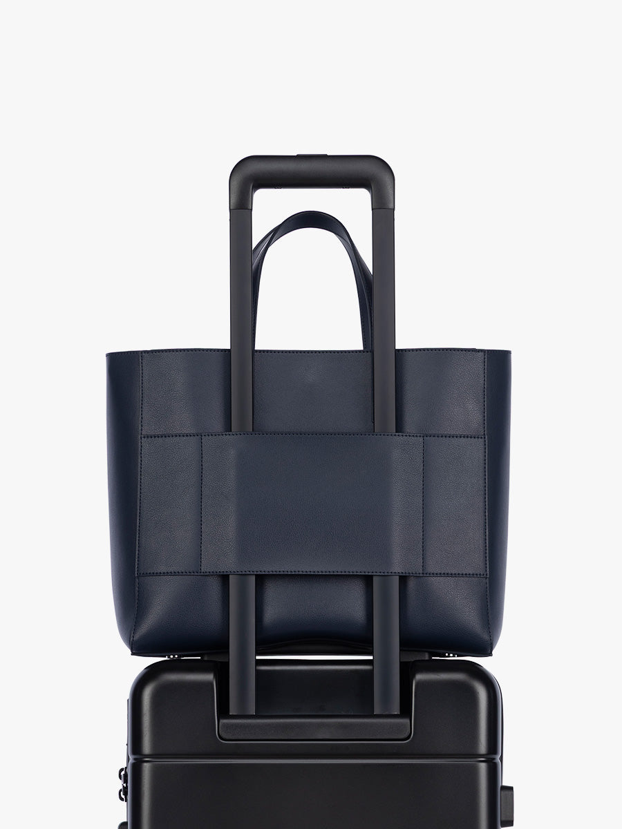 Trolley sleeve feature of CALPAK Haven 15" Laptop Tote in dark blue Navy; ATS2501-NAVY