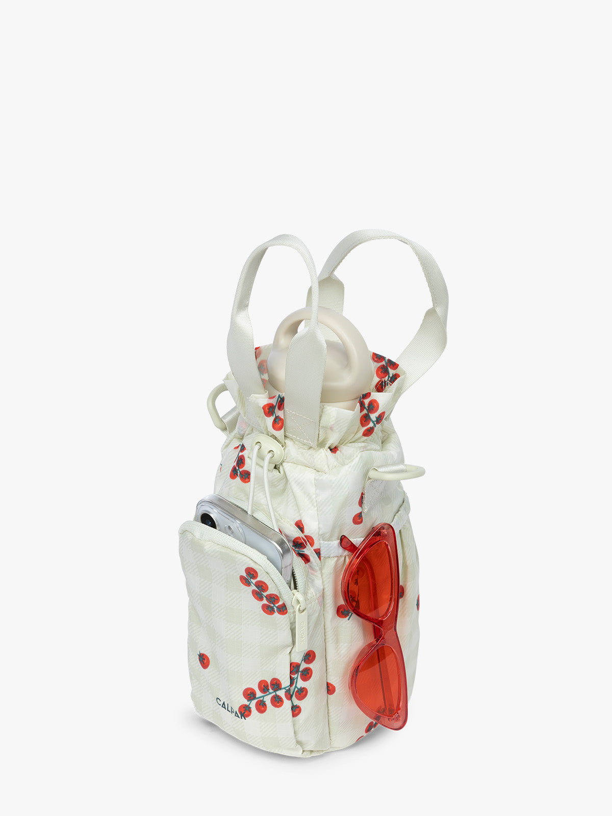 Water bottle and items in the CALPAK Water Bottle Holder in light green Celadon and white gingham with tomato print; AWH2101-CELADON-TOMATO-PICNIC
