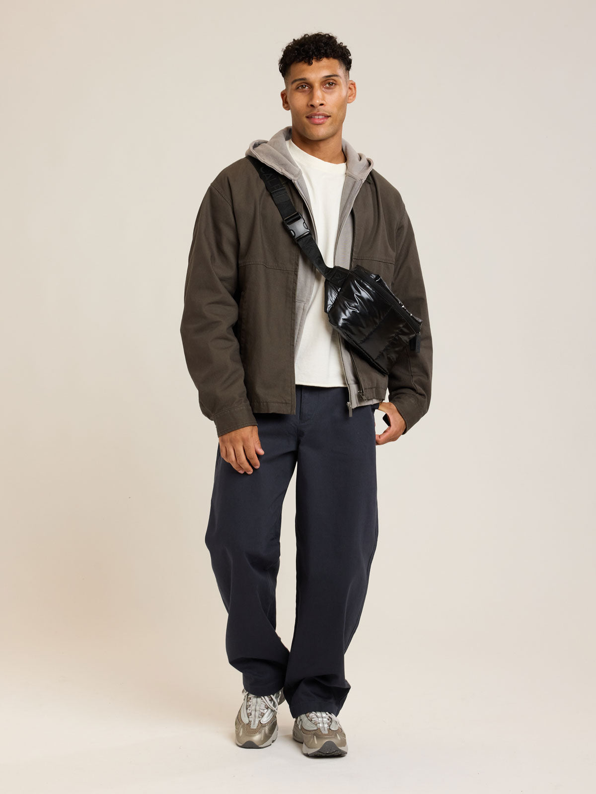 Model wearing CALPAK Luka Belt Bag in Glazed Black ; BB1901-GLAZED-BLACK