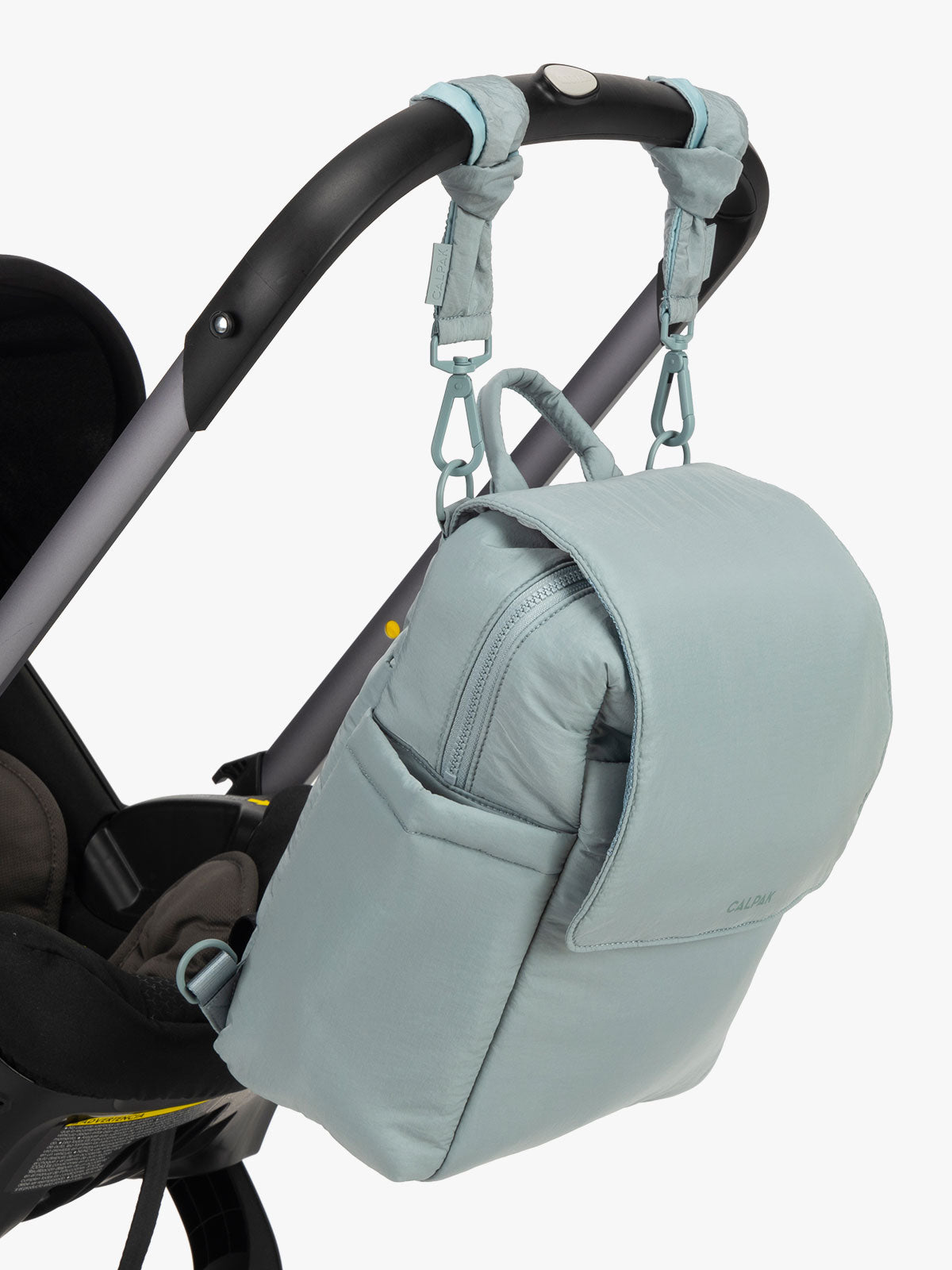 CALPAK Convertible Mini Diaper Backpack in light blue Bluebell hanging on a stroller with stroller straps ; BPC2401-BLUEBELL
