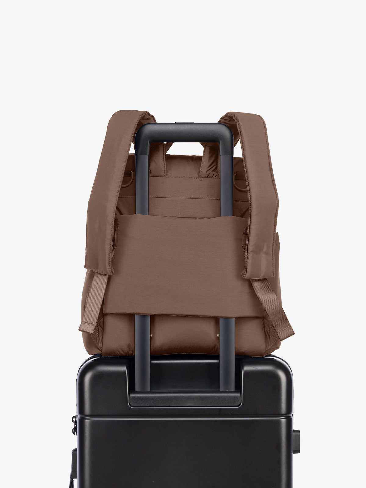 Luggage trolley sleeve of the CALPAK Mini Diaper Backpack in brown Hazelnut on a white background; BPC2402-HAZELNUT