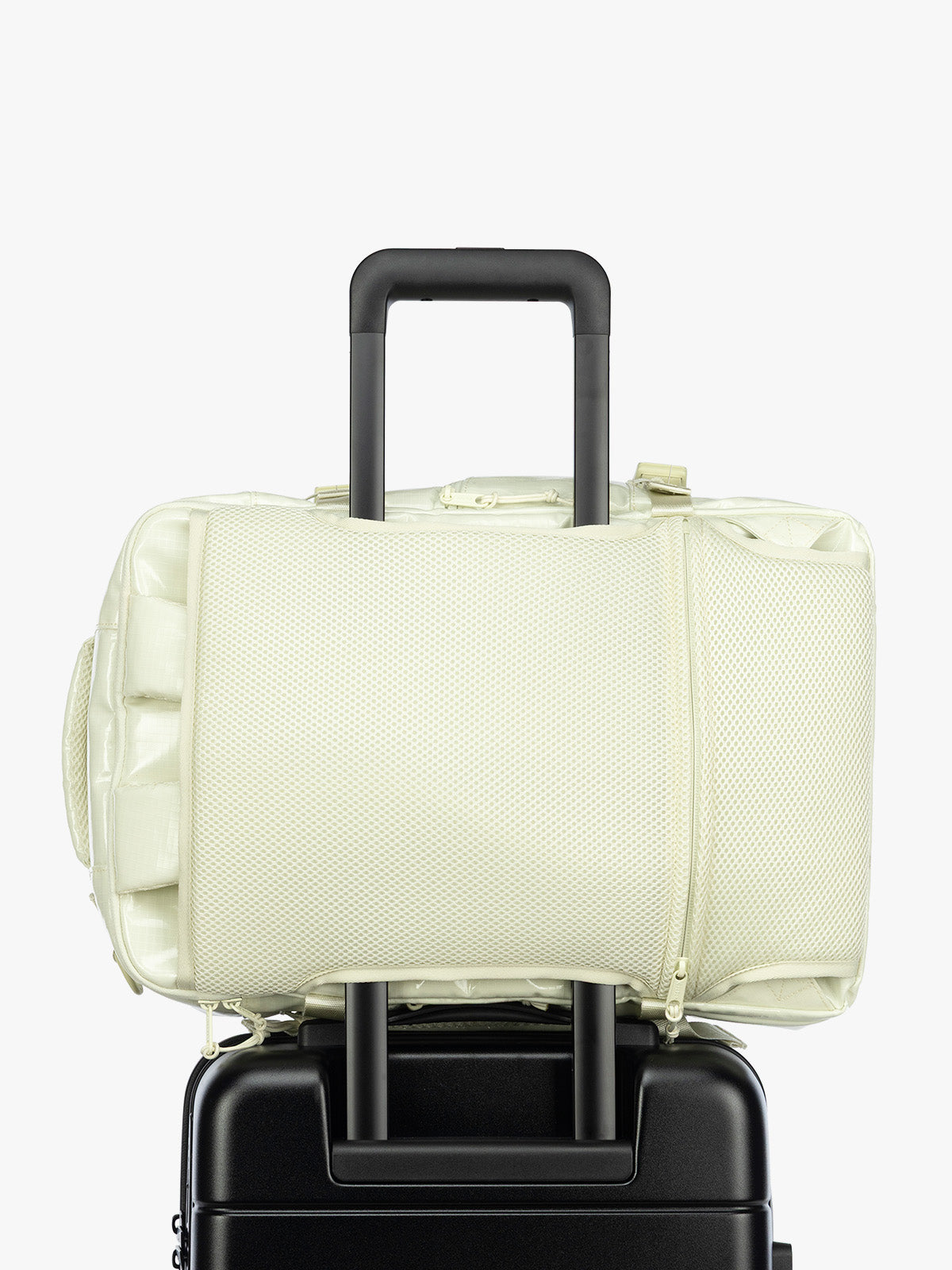 Luggage Trolley sleeve of the CALPAK Terra 26L Laptop Duffel Backpack with multiple pockets in light green Celadon on a white background; BPH2201-CELADON