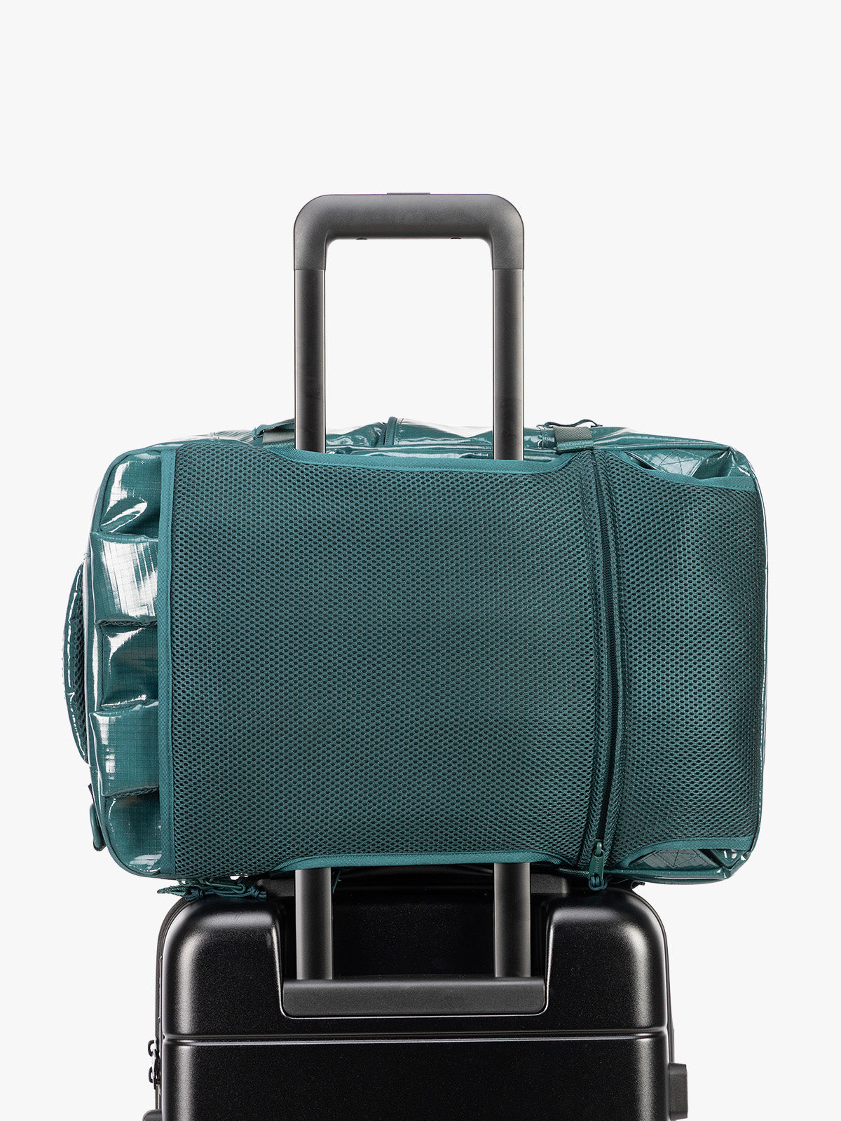 Backside trolley sleeve of CALPAK Terra 26L Laptop Backpack in dark blue green Kale with multiple pockets on a white background; BPH2201-KALE