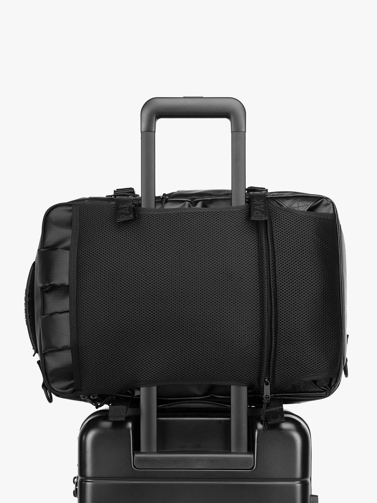 CALPAK Terra 26L Laptop Duffel Backpack in black Matte Obsidian on luggage with trolley sleeve; BPH2201-MATTE-OBSIDIAN