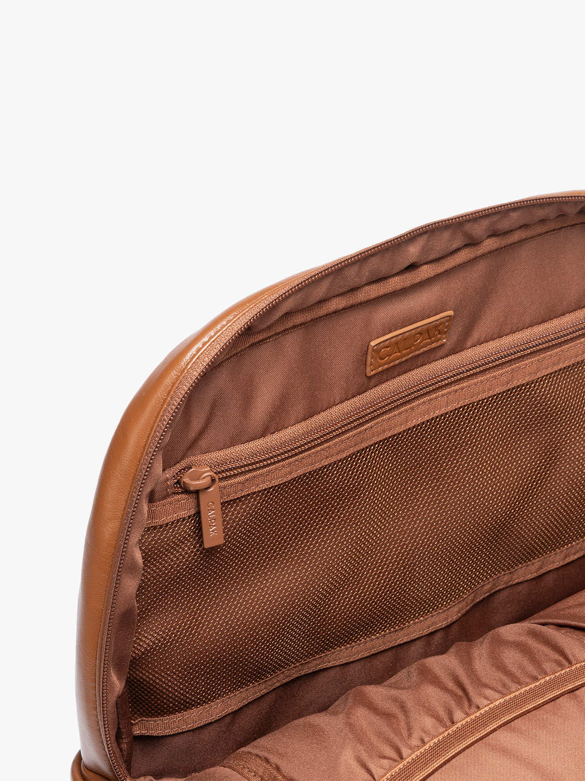 Inside zipper of CALPAK Honey Brown Luka 15 inch Laptop Backpack in vegan leather with a glossy finish, featuring a top carry handle, a main zippered compartment, and a front slip pocket, shown against a plain white background; BPL2001-HONEY-BROWN-PU