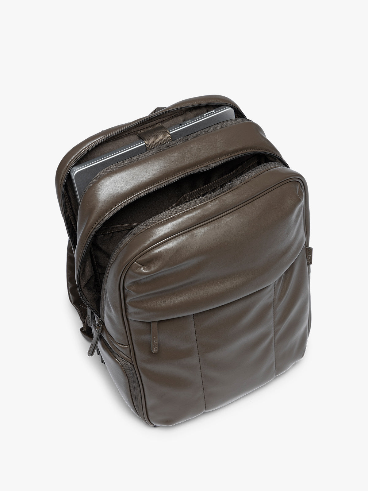 laptop sleeve of CALPAK Mushroom brown Luka 15 inch Laptop Backpack in vegan leather with a glossy finish, featuring a top carry handle, a main zippered compartment, and a front slip pocket, shown against a plain white background; BPL2001-MUSHROOM-PU
