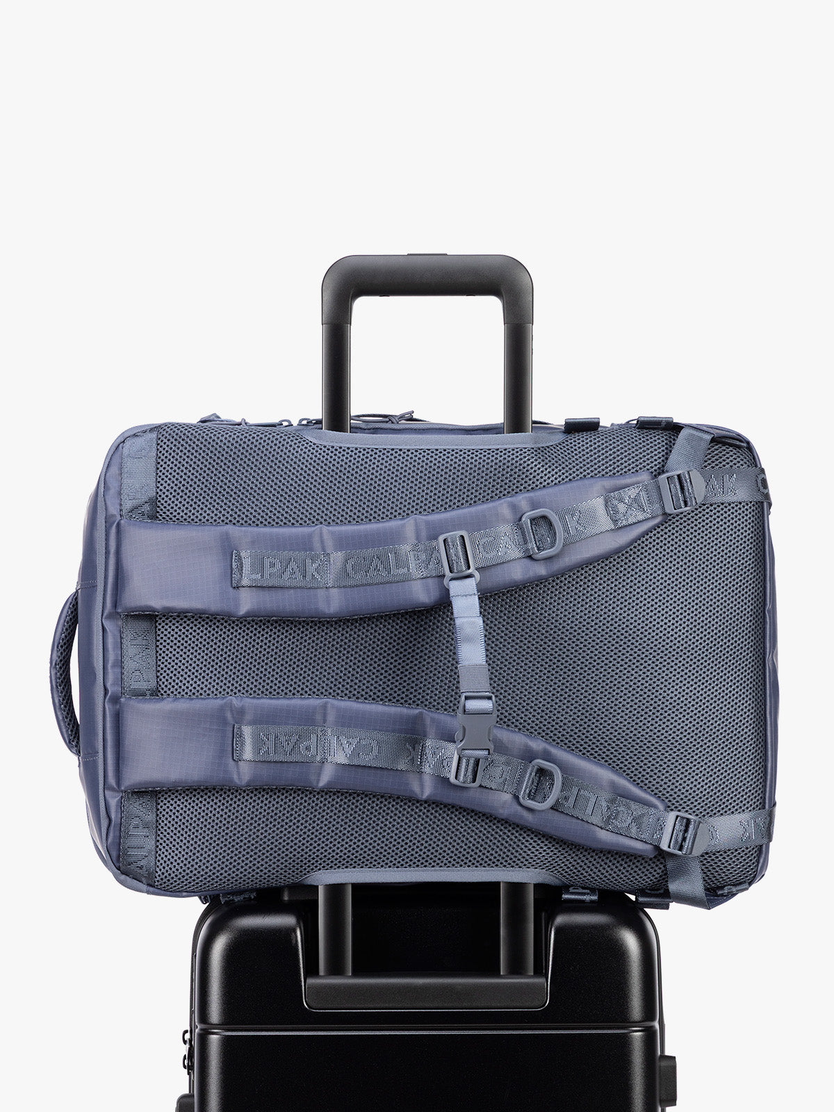 Back trolley sleeve of CALPAK Terra 35L Laptop Backpack Duffel in matte dark blue Indigo with tan accents on a white background; BPTL2601-INDIGO