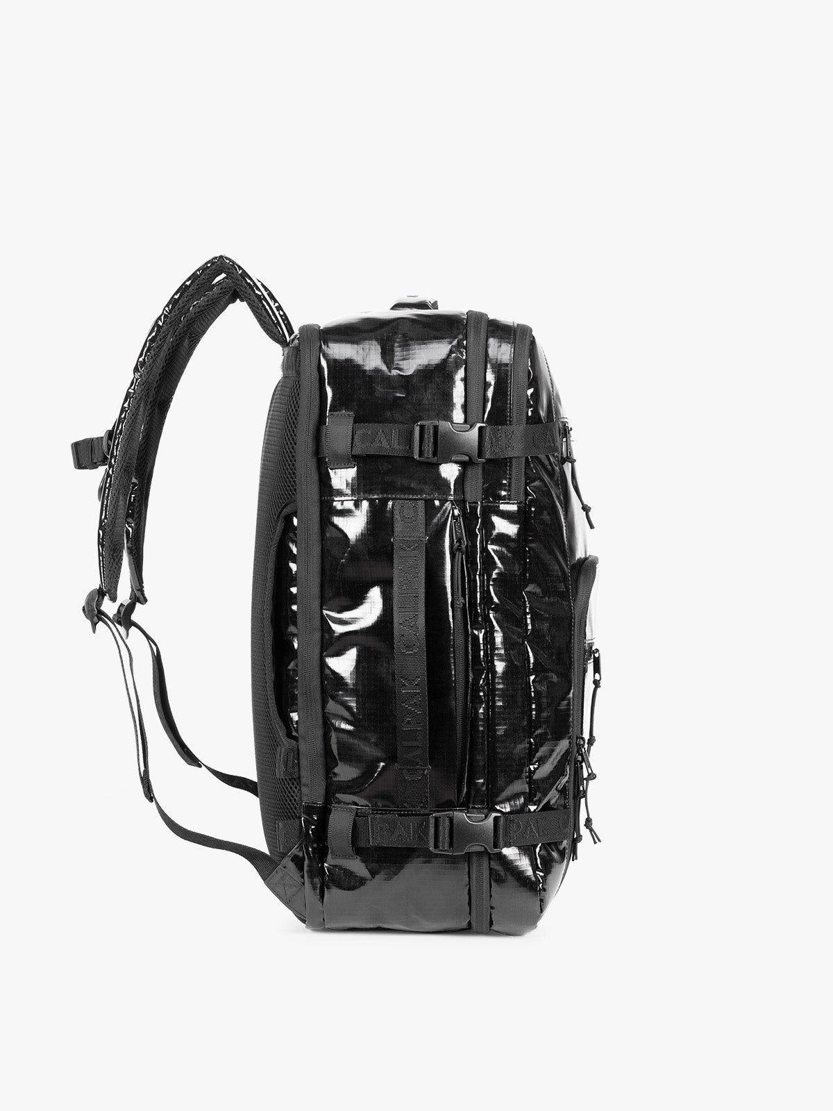 Side view of  the CALPAK Terra 35L Laptop Duffel Backpack in shiny black Obsidian on a white background; BPTL2601-OBSIDIAN