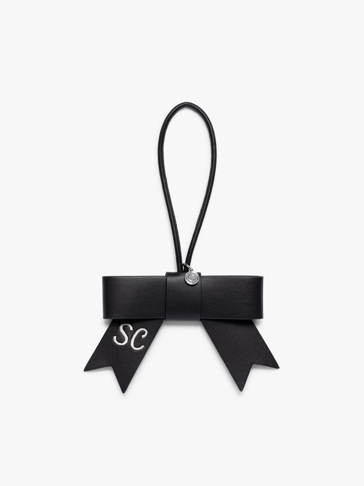  Black CALPAK Personalized Bow Bag Charm with a black strap and silver-tone metal ring at the top that is personalized ; BWBC2601-BLACK