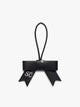  Black CALPAK Personalized Bow Bag Charm with a black strap and silver-tone metal ring at the top that is personalized ; BWBC2601-BLACK