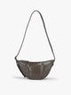 A dark brown vegan leather Luka Crescent shoulder bag with a long thin strap, shown against a plain light gray background; CBL2601-MUSHROOM-PU