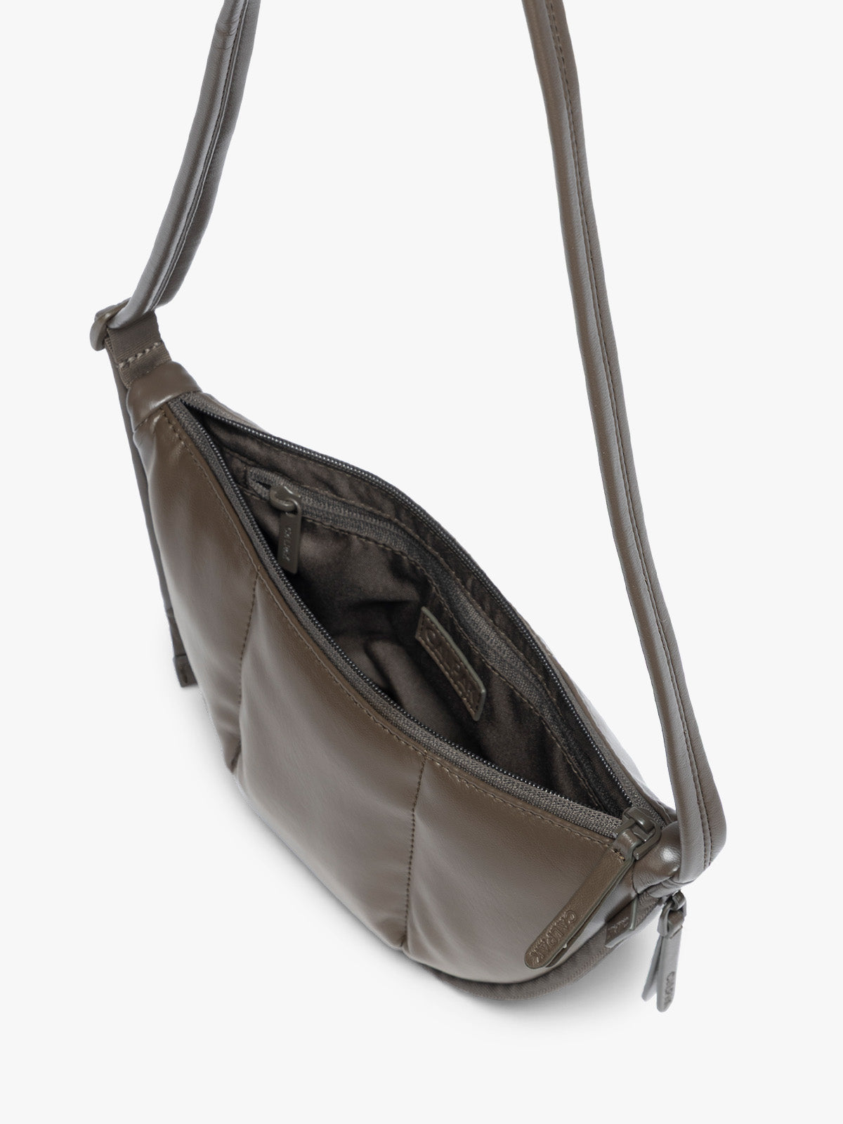 Top view of opened zipper of a dark brown vegan leather Luka Crescent shoulder bag with a long thin strap, shown against a plain light gray background; CBL2601-MUSHROOM-PU