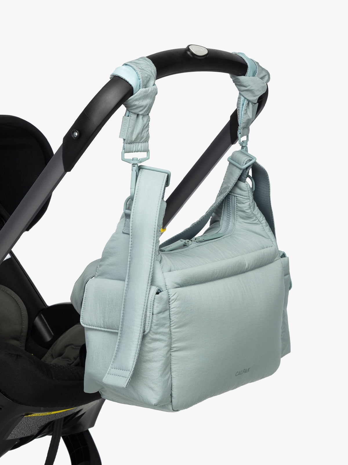 CALPAK Crossbody Diaper Bag in light blue Bluebell strapped on stroller with Stroller Straps; CDB2501-BLUEBELL