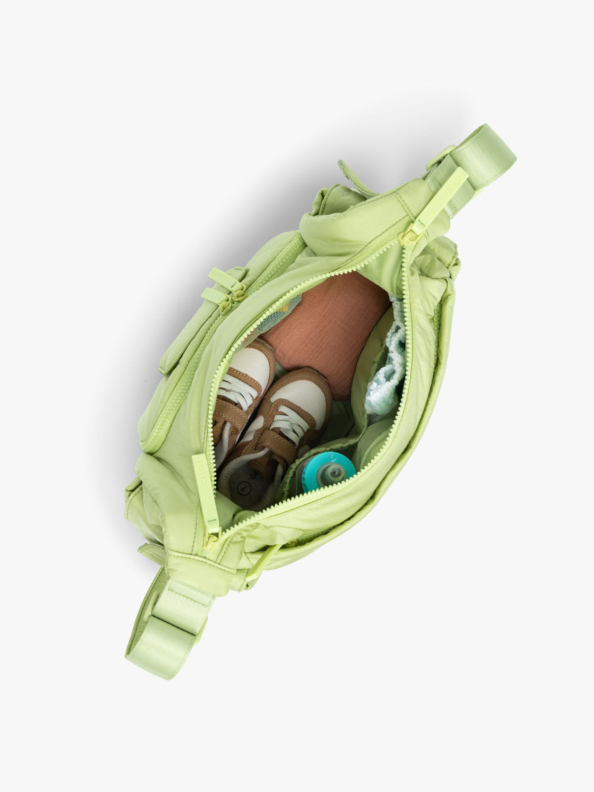 CALPAK Crossbody Diaper Bag in light green Lime top view with zipper opened, showing interior of bag; CDB2501-LIME