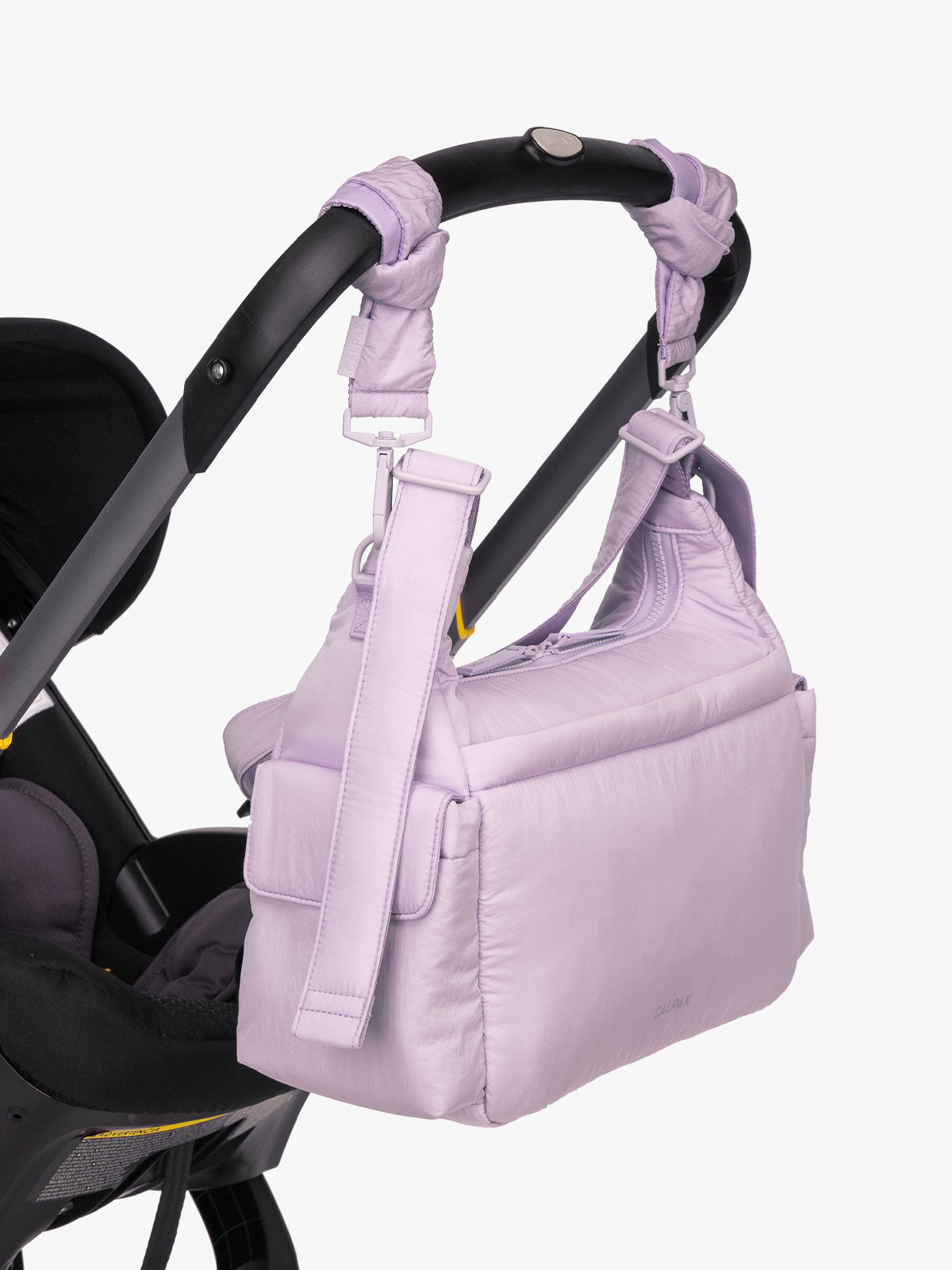 CALPAK Crossbody Diaper Bag in light purple ORCHID strapped on stroller with Stroller Straps; CDB2501-ORCHID