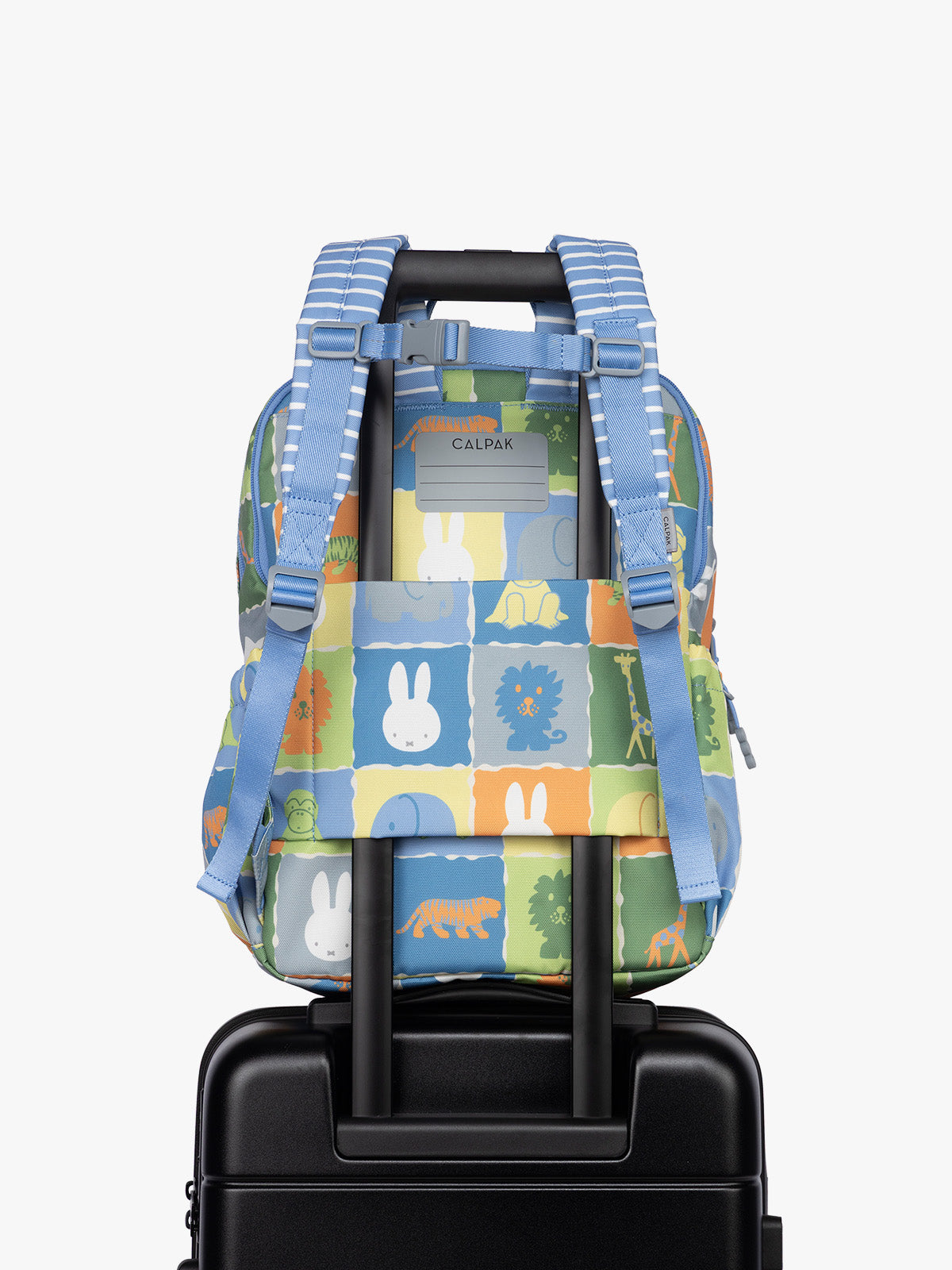 Back side with luggage trolley sleeve of CALPAK Kids Large Backpack with Miffy and blue colorful animal pattern on a white background; CKBL2501-MIFFY-BLUE-ZOO-TRIP