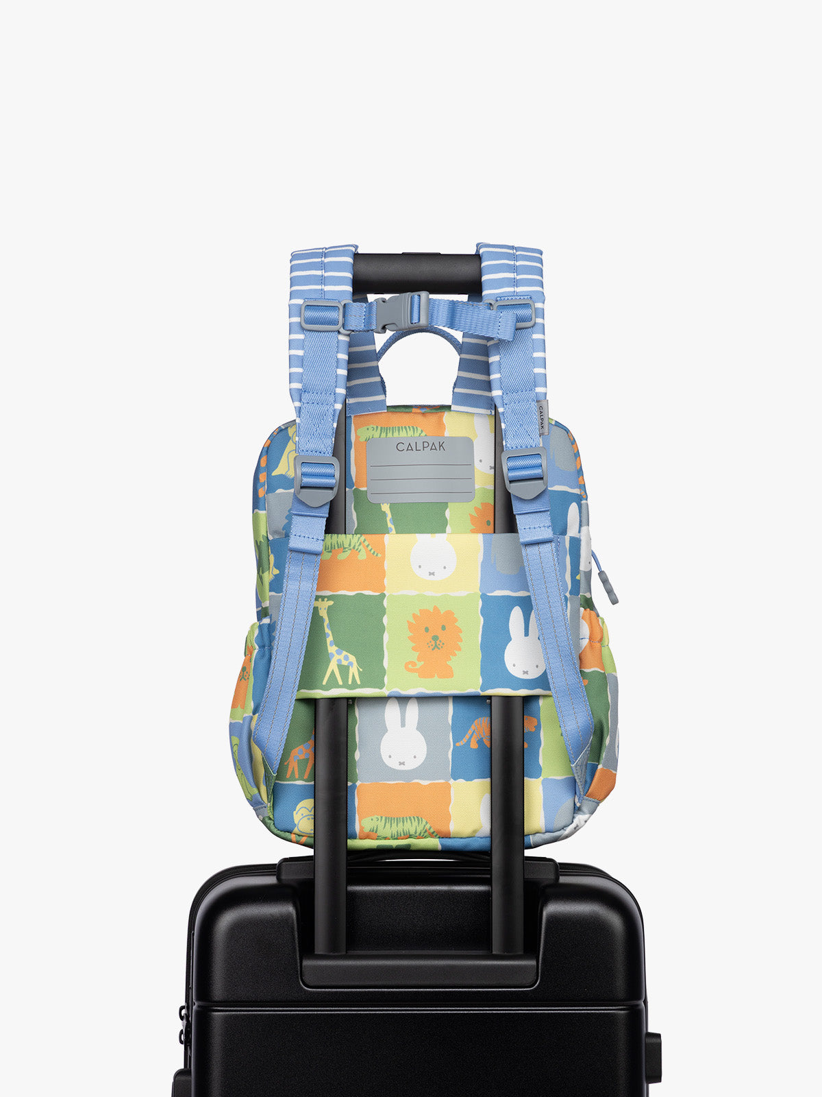 Back luggage sleeve of CALPAK Kids Small Backpack with Miffy and blue colorful animal pattern on a white background; CKBS2501-MIFFY-BLUE-ZOO-TRIP