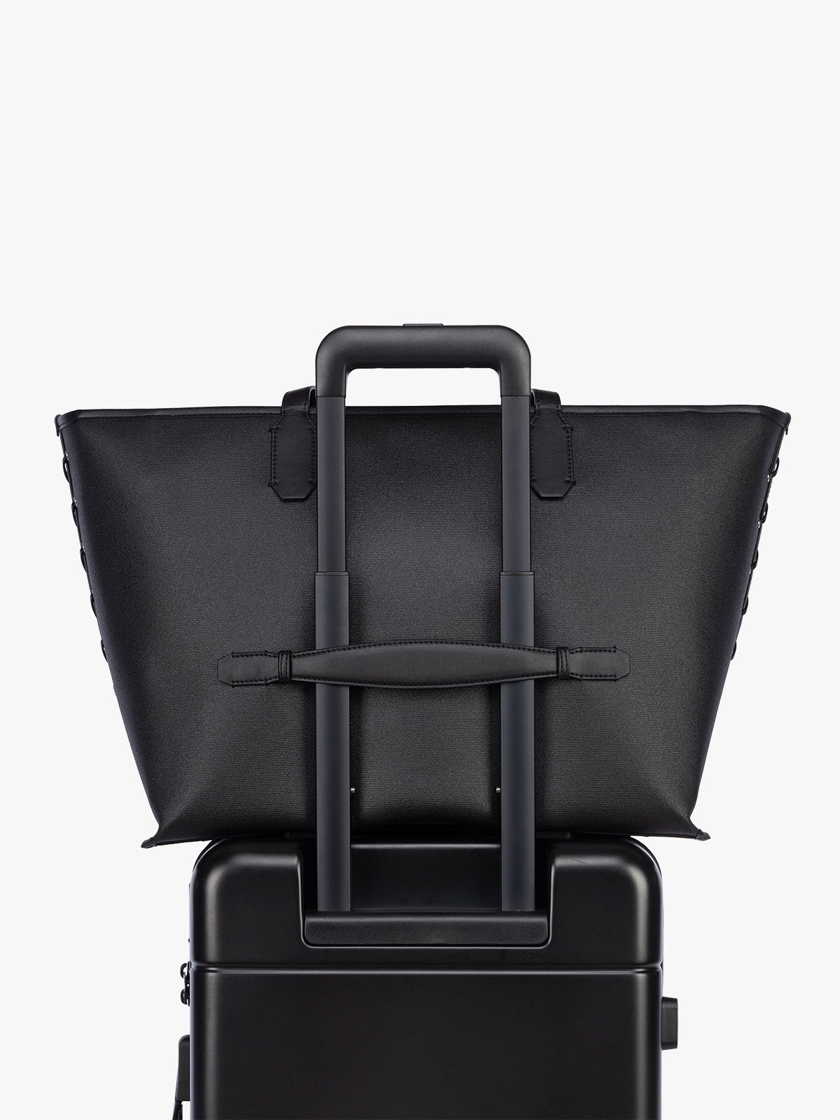Trolley sleeve of CALPAK Colette 15" Canvas Laptop Tote in black canvas material ; CLCT2601-BLACK