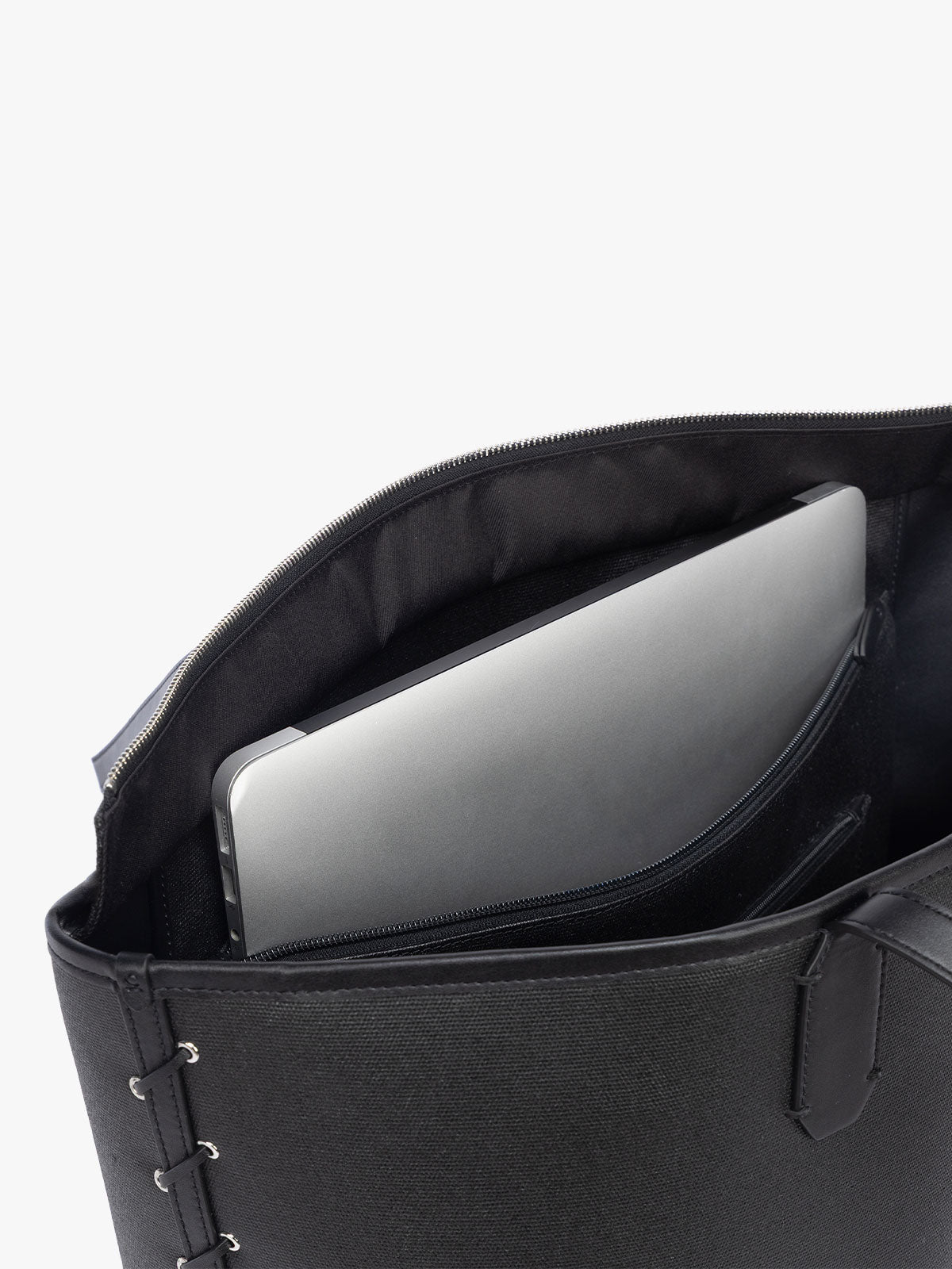 Laptop sleeve of CALPAK Colette 15" Canvas Laptop Tote with zipper and interior laptop sleeve in black canvas material ; CLCT2601-BLACK