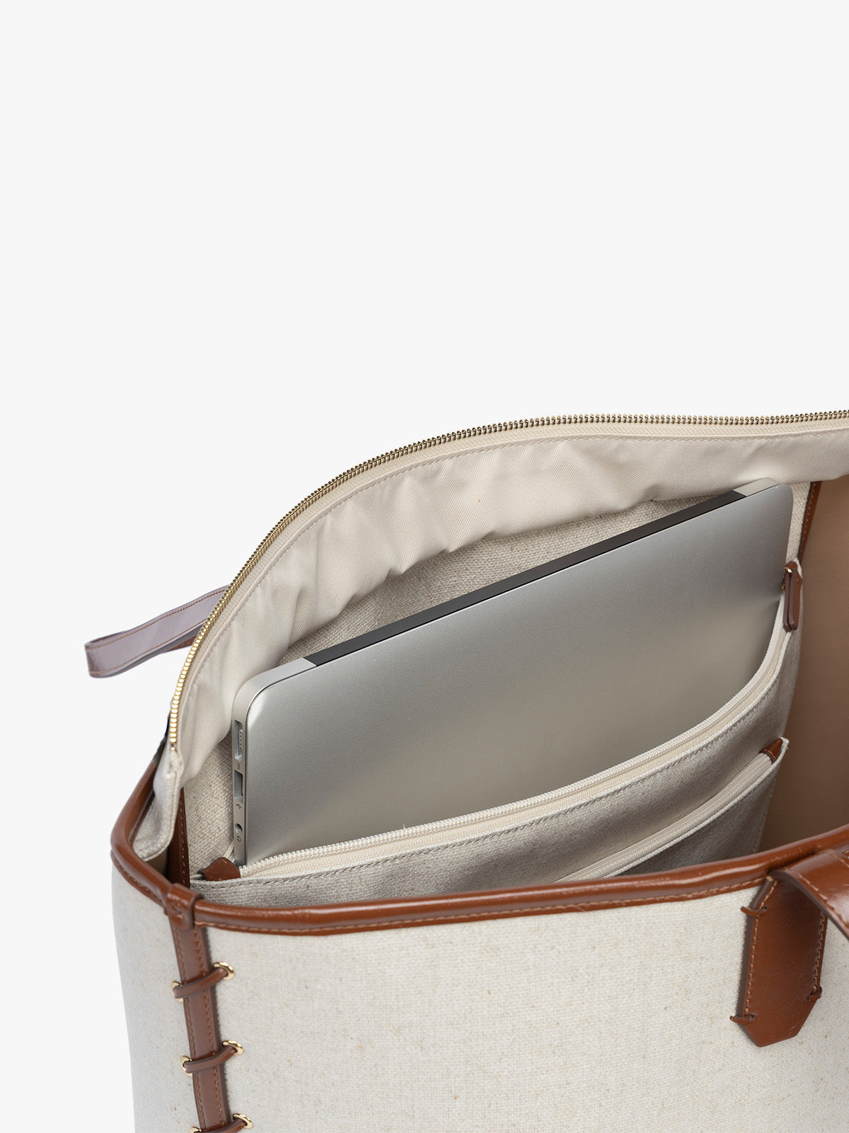 Laptop sleeve of CALPAK Colette 15" Canvas Laptop Tote with zipper and laptop sleeve in beige canvas material with brown finishing in Natural Brown; CLCT2601-NATURAL-BROWN